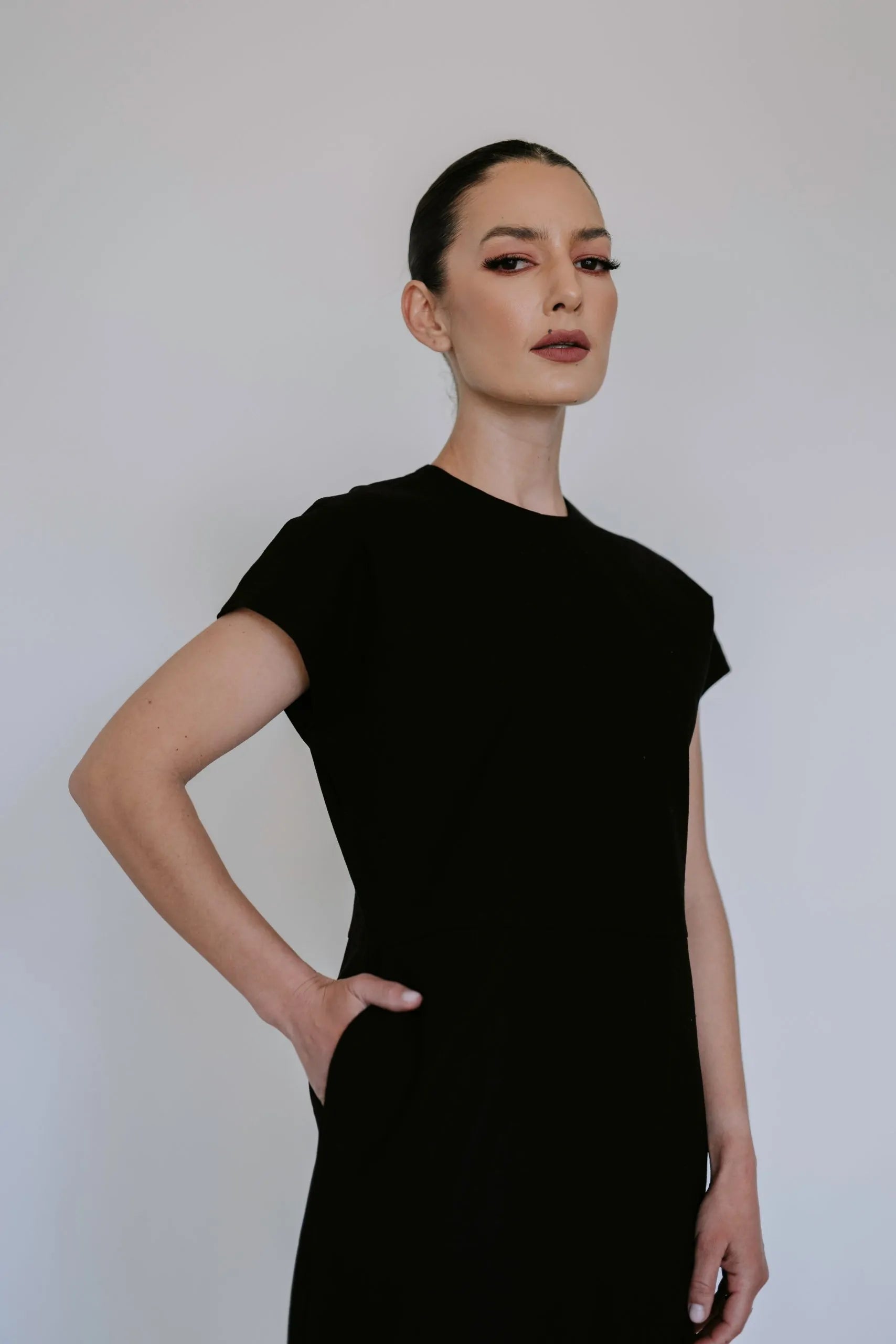 Black linen blend midi dress by Lika Designs, shown on model, featuring a flowy silhouette and elegant design.