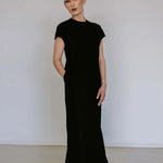Black linen blend midi dress by Lika Designs, shown on a hanger with a flowing, elegant silhouette and natural fabric texture.