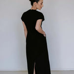 Black linen blend midi dress by Lika Designs on consignment, featuring a flowing silhouette and elegant design.