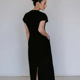 Black linen blend midi dress by Lika Designs on consignment, featuring a flowing silhouette and elegant design.