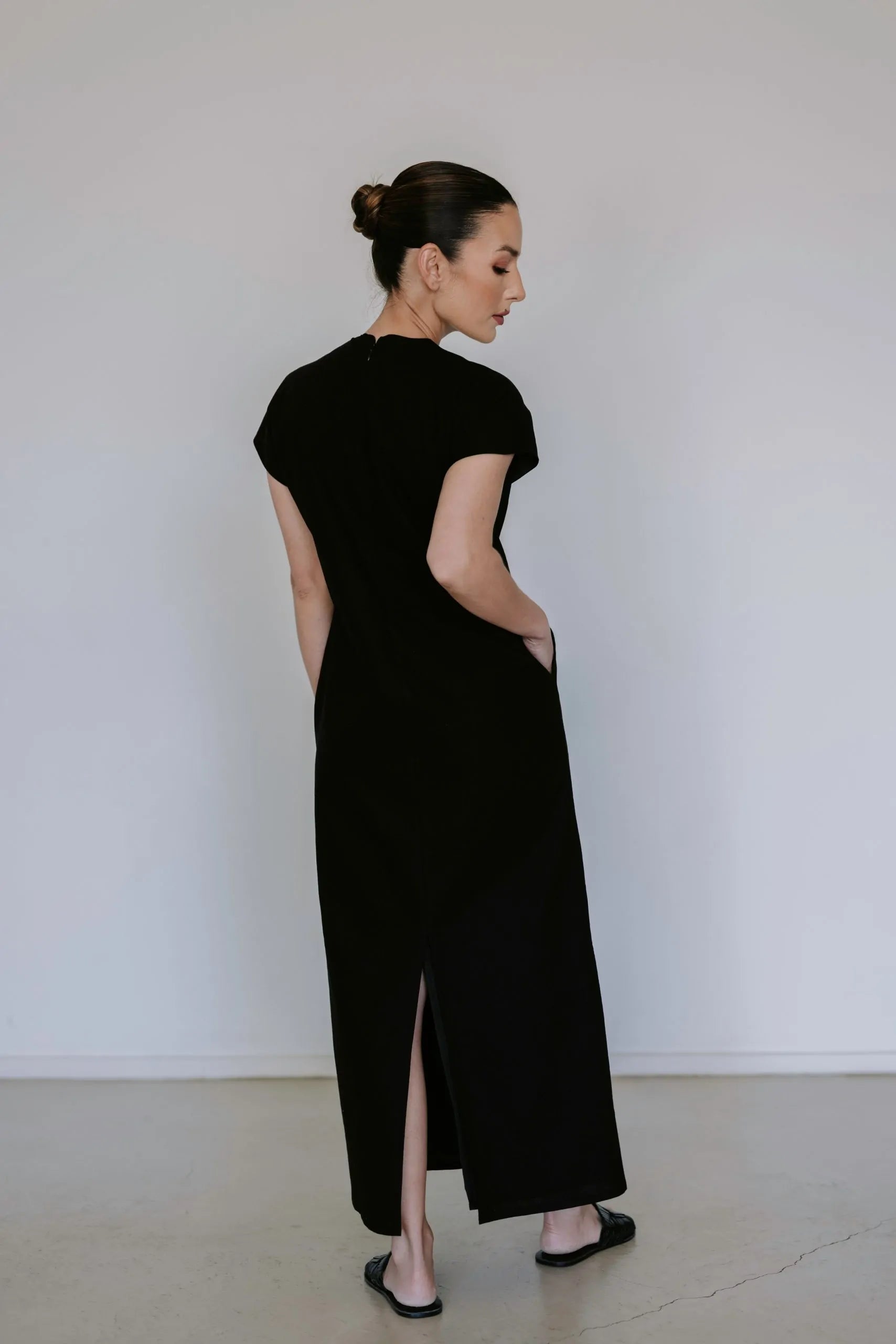 Black linen blend midi dress by Lika Designs on consignment, featuring a flowing silhouette and elegant design.