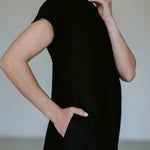 Black linen blend midi dress by Lika Designs featuring a flowy silhouette and stylish design, displayed on a mannequin.