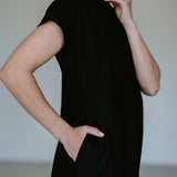 Black linen blend midi dress by Lika Designs featuring a flowy silhouette and stylish design, displayed on a mannequin.