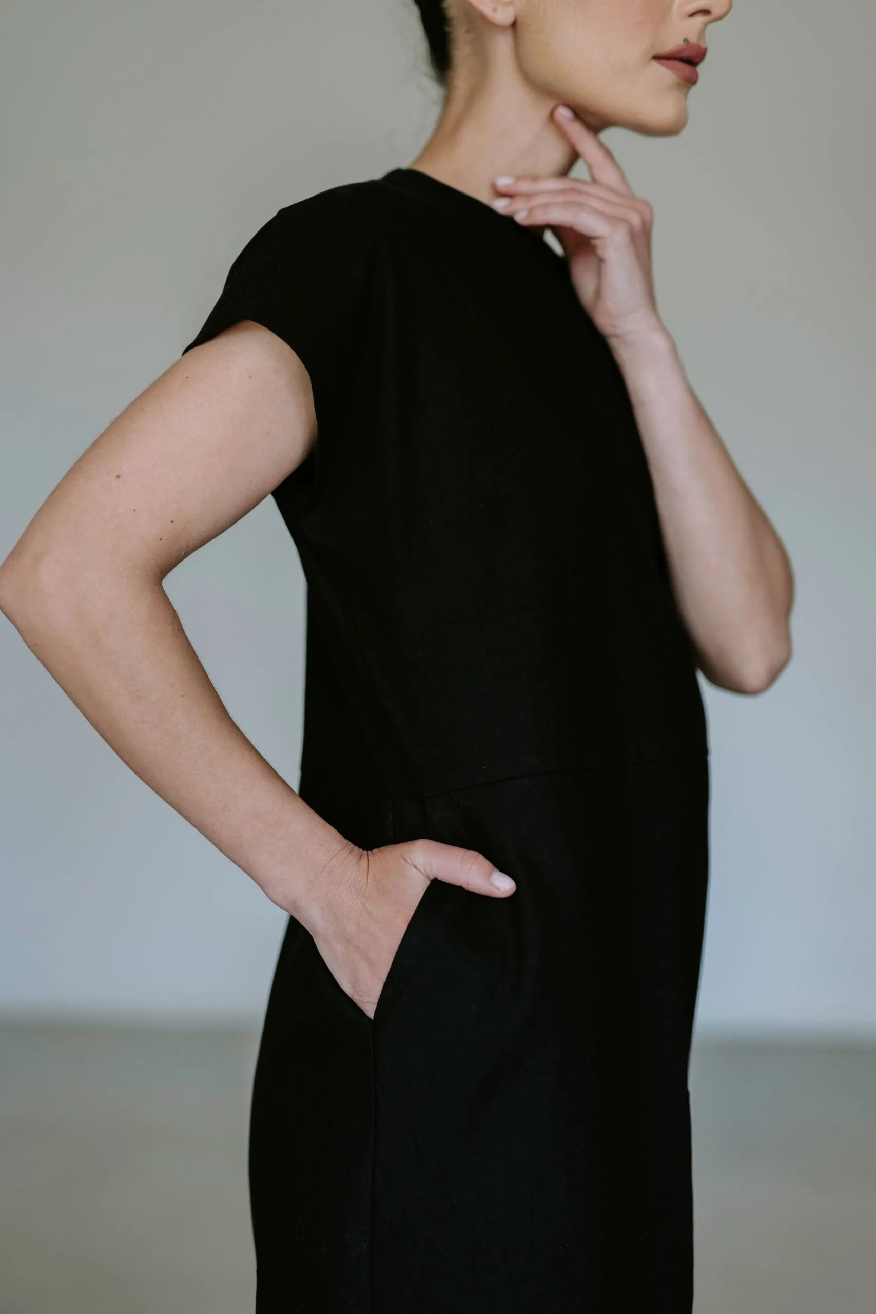 Black linen blend midi dress by Lika Designs featuring a flowy silhouette and stylish design, displayed on a mannequin.