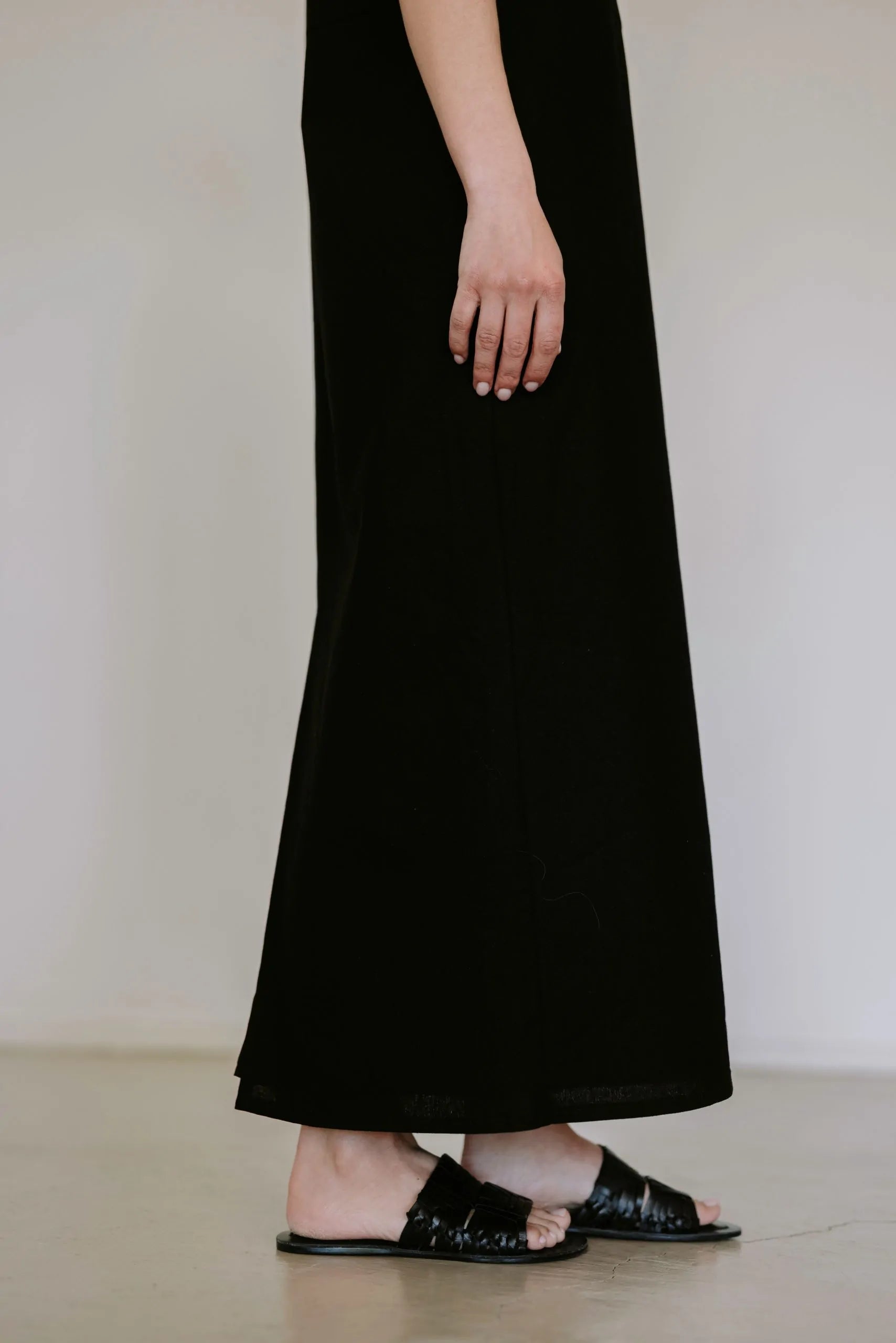Black linen blend midi dress by Lika Designs, displayed on a mannequin with a relaxed fit and stylish design.