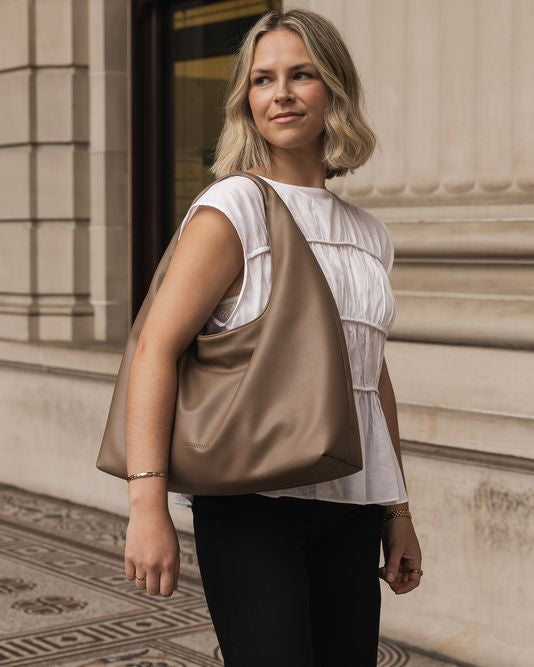 LouenHide Monaco shoulder bag in mocha leather, styled with a model showcasing the elegant design and spacious interior.