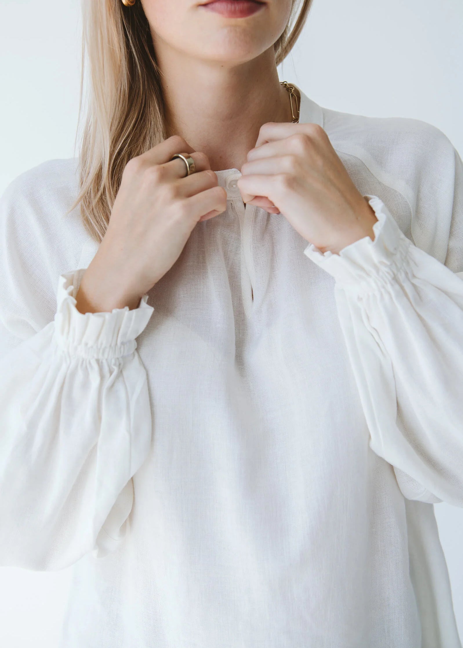 Trinity Denny reversible long sleeve shirt in milk color, made from natural fabric, displayed on a hanger.