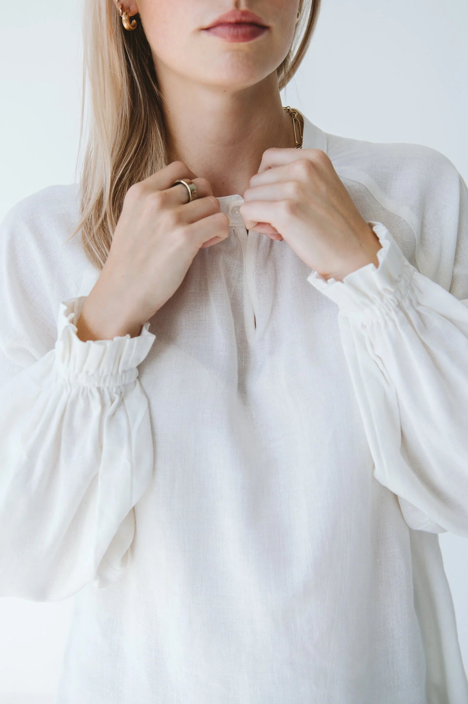 Trinity Denny reversible long sleeve shirt in milk color, made from natural fabric, displayed on a hanger.