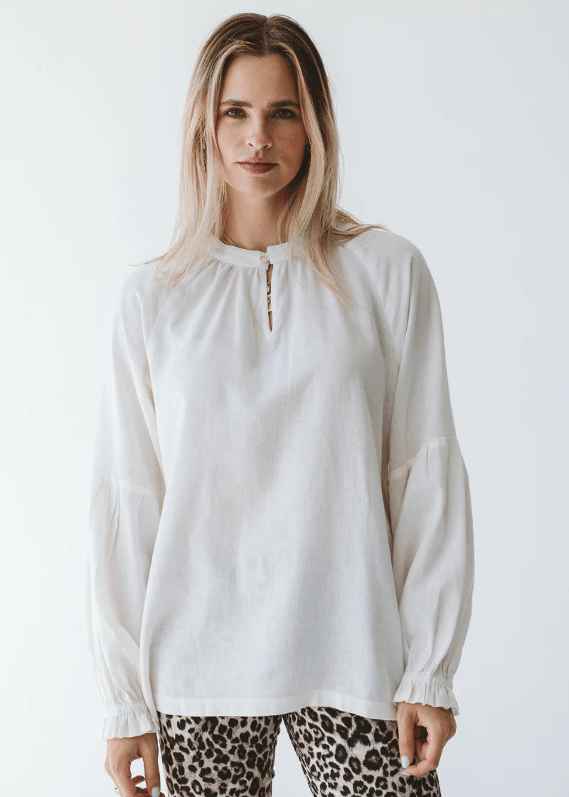 Trinity Denny reversible long sleeve shirt in milk color, made from natural fabric, displayed on a neutral background.