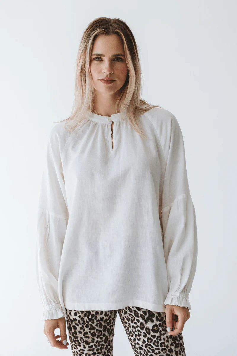 Trinity Denny reversible long sleeve shirt in milk color, made from natural fabric, displayed on a neutral background.