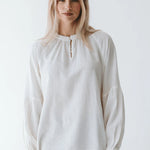 Trinity Denny reversible long sleeve shirt in milk color, made from natural fabric, displayed on a neutral background.