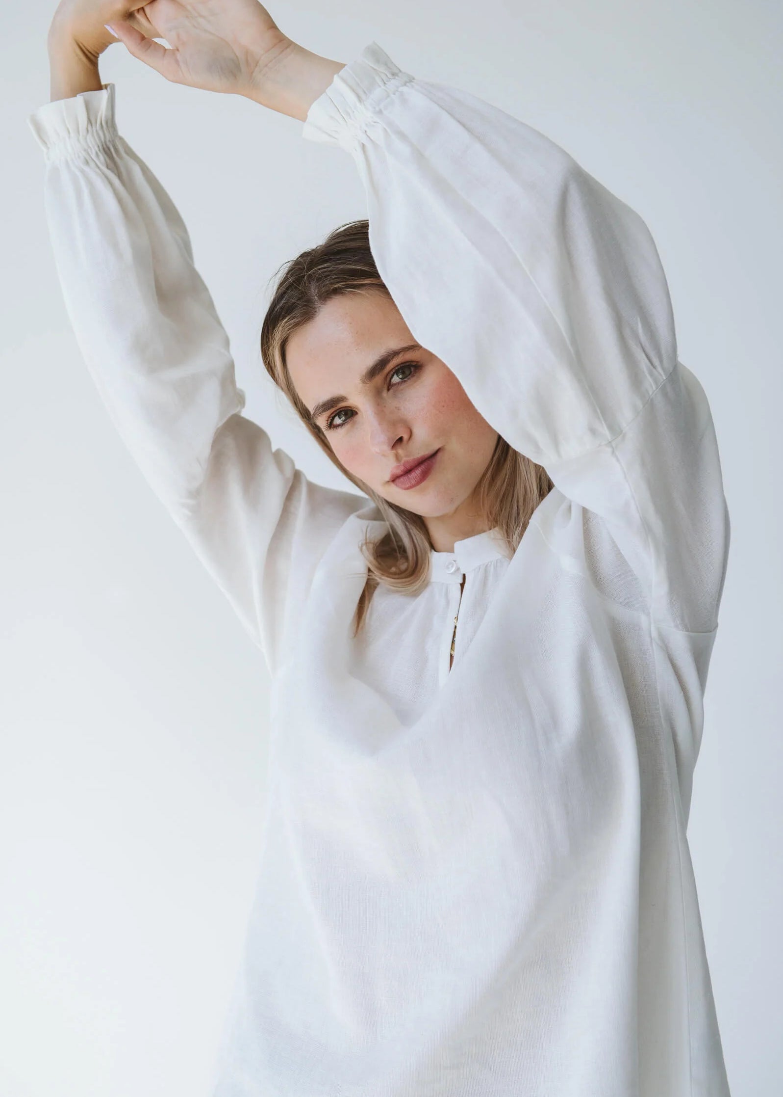 Trinity Denny reversible long sleeve shirt in white with balloon sleeves, made from natural fabric, stylish consignment apparel.