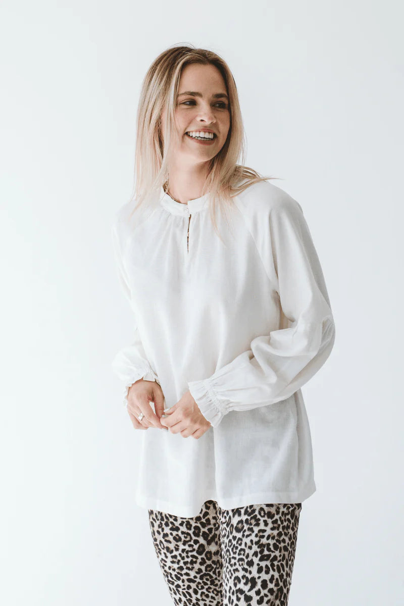 Trinity Denny reversible long sleeve shirt in white, made from natural fabric, shown flat with front and back views.