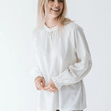 Trinity Denny reversible long sleeve shirt in white, made from natural fabric, shown flat with front and back views.