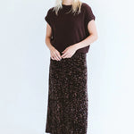 Chocolate sequins skirt by Trinity, made in South Africa, shown on a model from the Winter Collection 2026.