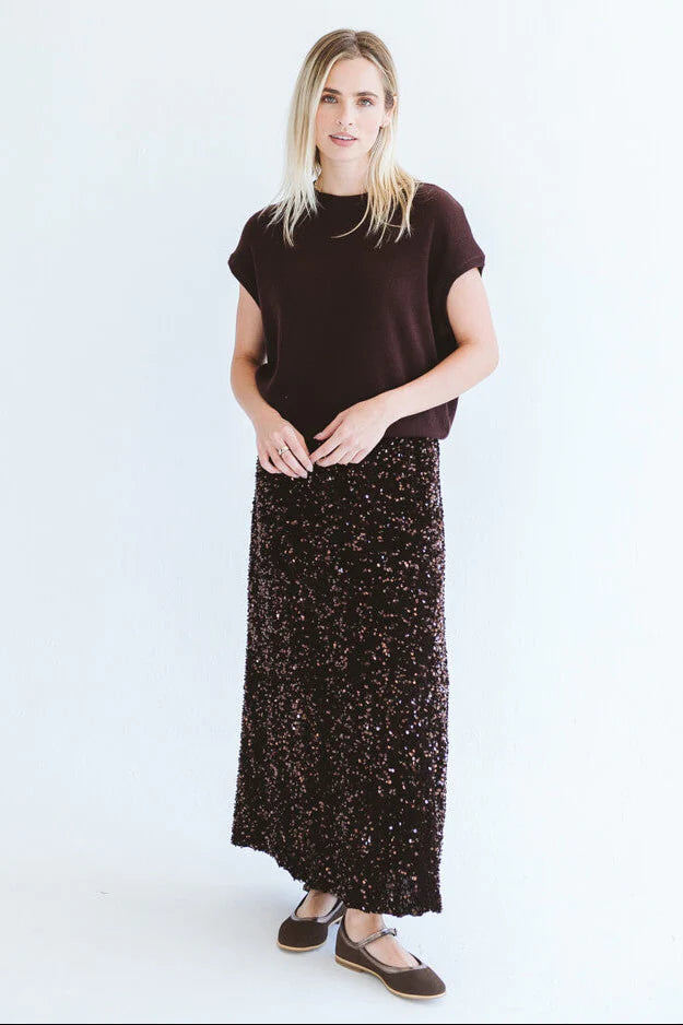 Chocolate sequins skirt by Trinity, made in South Africa, shown on a model from the Winter Collection 2026.