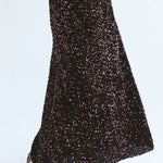 Close-up of Trinity chocolate sequins skirt from the Winter Collection, showcasing shiny embellishments and elegant design.