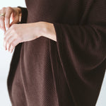 Trinity chocolate poncho made of cozy, stylish outerwear fabric, perfect for cold weather and travel comfort.