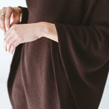 Trinity chocolate poncho made of cozy, stylish outerwear fabric, perfect for cold weather and travel comfort.