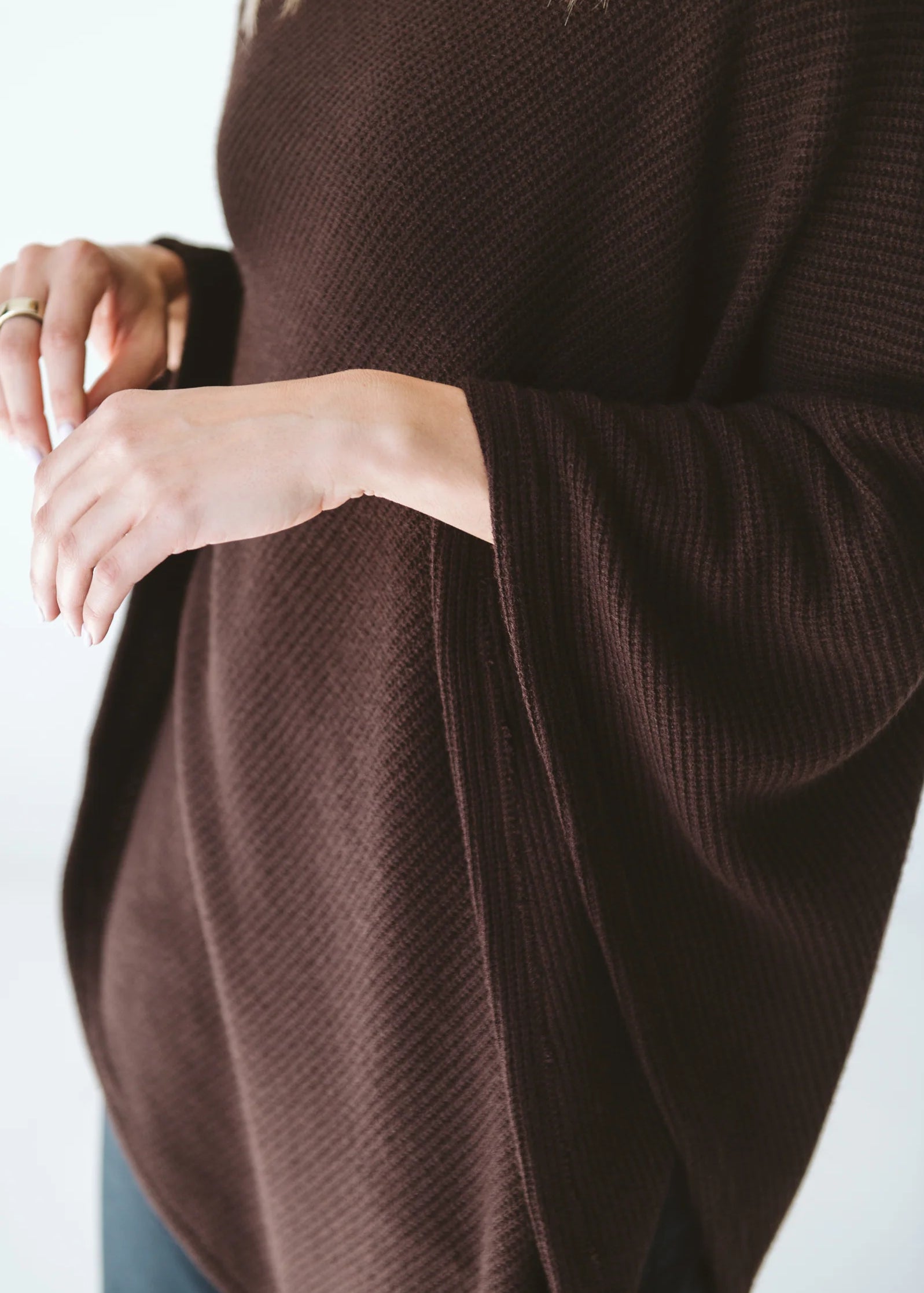 Trinity chocolate poncho made of cozy, stylish outerwear fabric, perfect for cold weather and travel comfort.