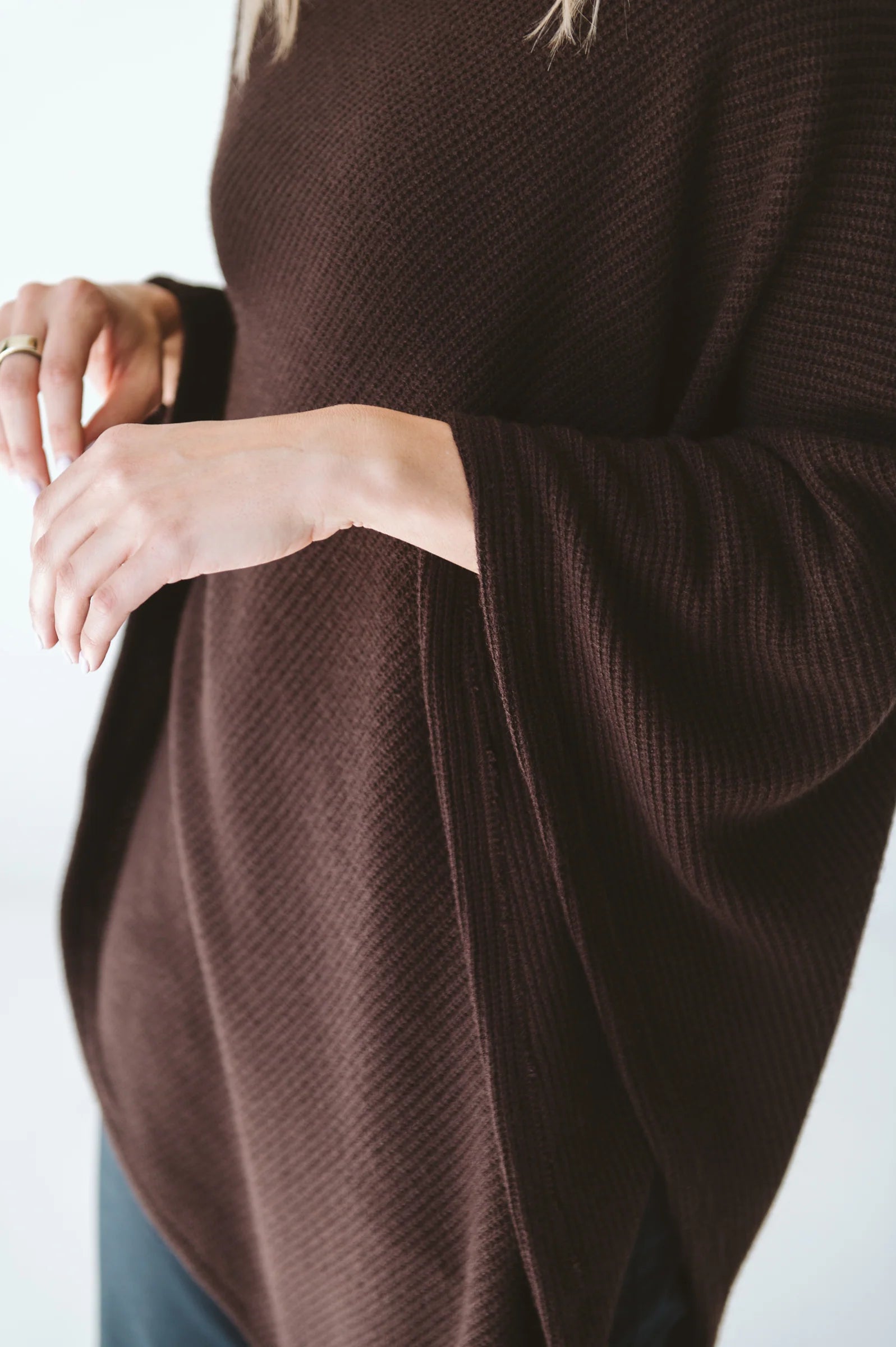 Trinity chocolate poncho made of cozy, stylish outerwear fabric, perfect for cold weather and travel comfort.