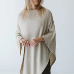 Cream Trinity poncho from consignment, cozy and comfortable, made in South Africa, ideal for cold weather and layered outerwear.