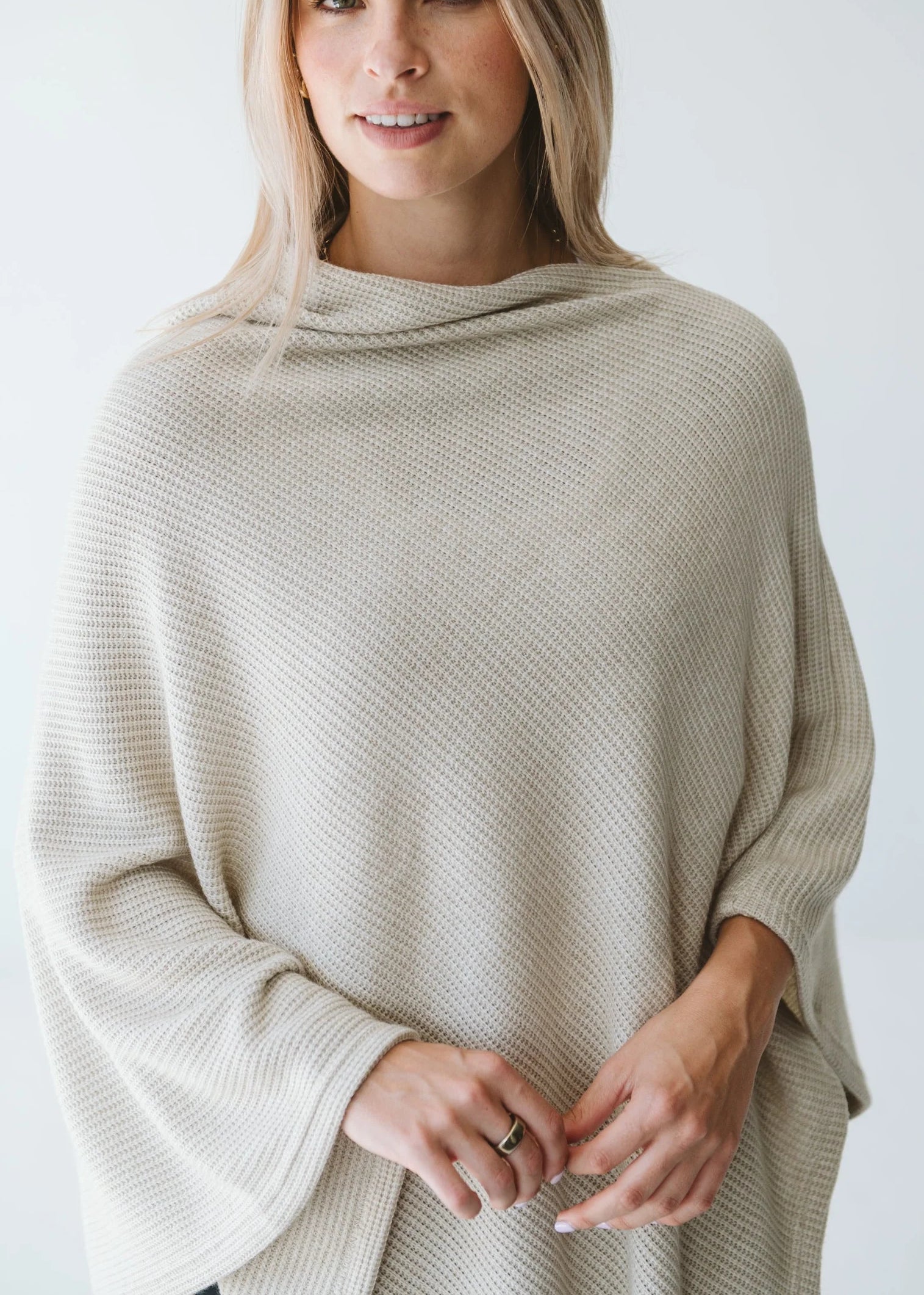 Cream Trinity poncho from consignment, cozy and stylish outerwear accessory made in South Africa, perfect for cold weather comfort.