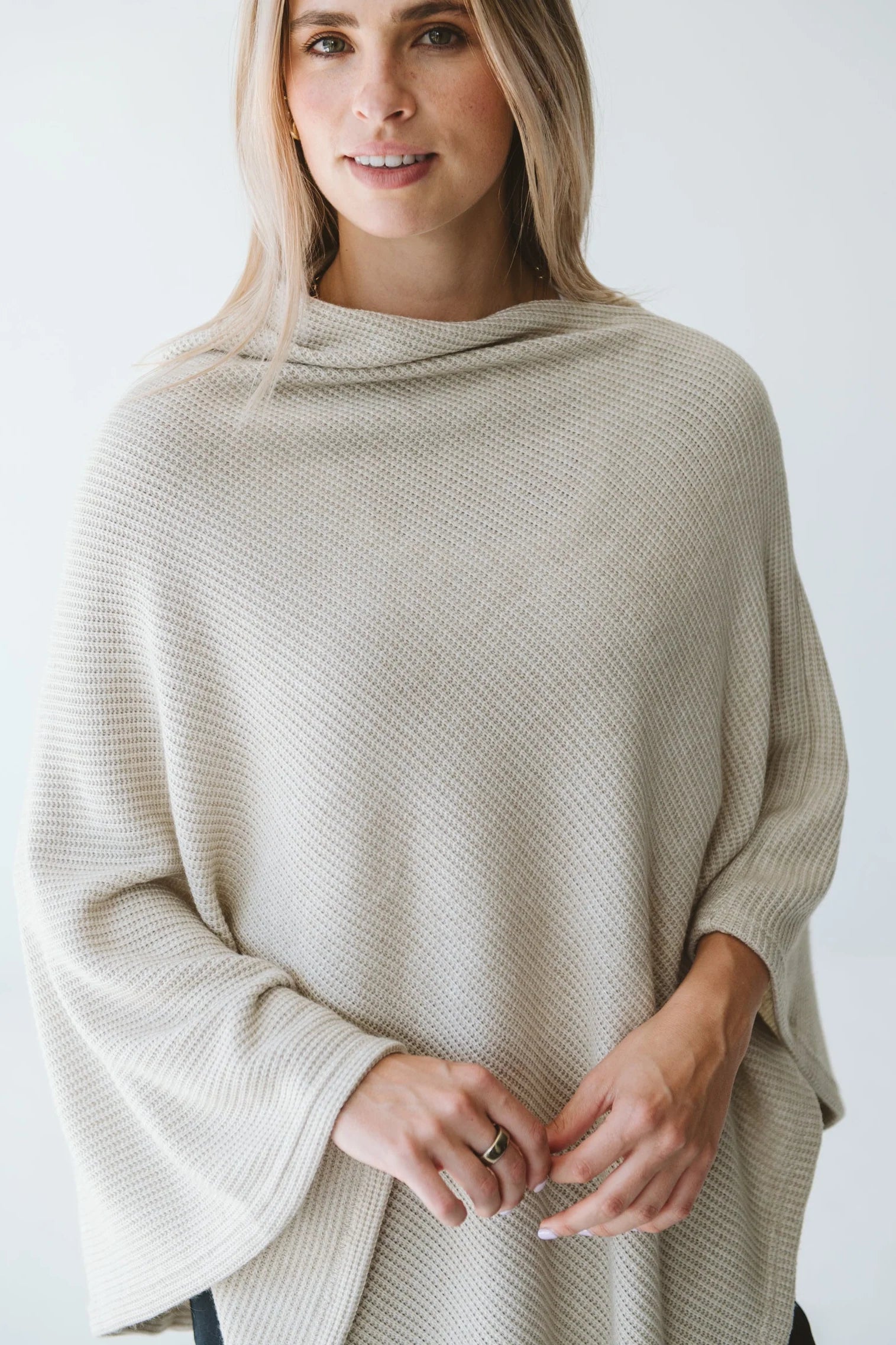 Cream Trinity poncho from consignment, cozy and stylish outerwear accessory made in South Africa, perfect for cold weather comfort.
