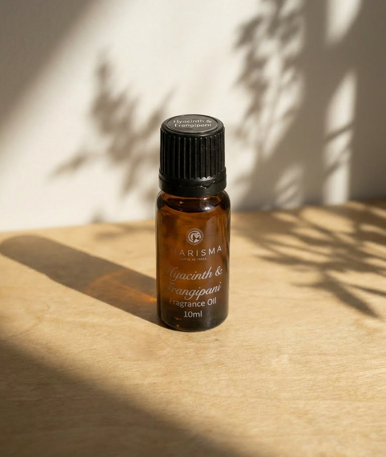 Charisma Candles hyacinth and frangipani fragrance oil in a clear bottle with a black cap, showcasing floral scent and elegant design.