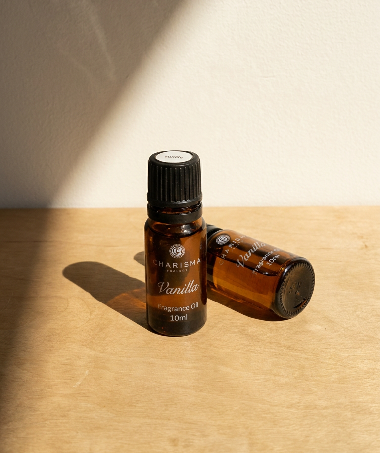Charisma Candles vanilla fragrance oil in a clear glass bottle with a white cap, showcasing the aromatic essential oil.