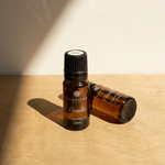 Charisma Candles vanilla fragrance oil in a clear glass bottle with a white cap, showcasing the aromatic essential oil.