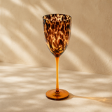 Tortoiseshell wine glass with elegant shape, featuring a warm, patterned design perfect for wine drinking.