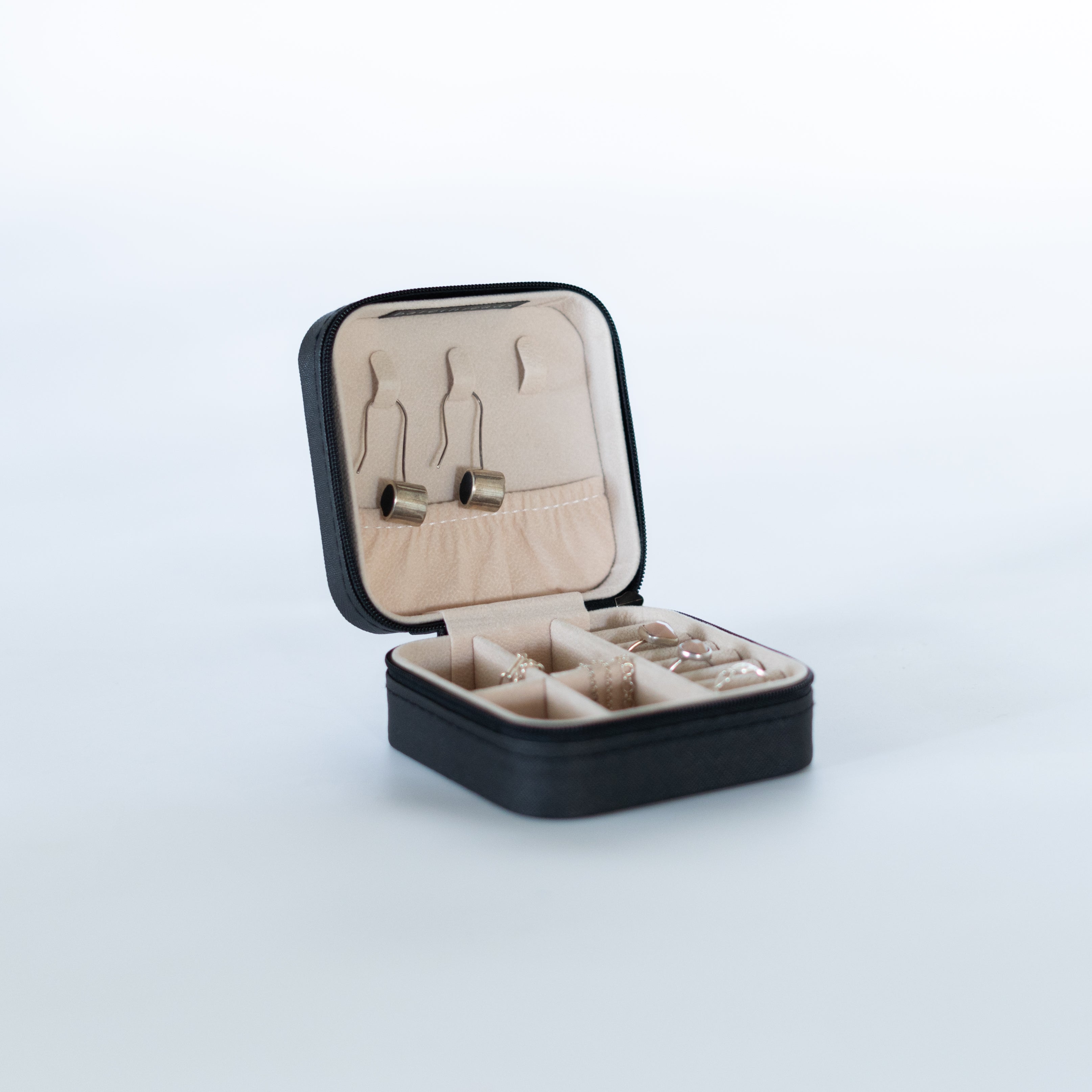 Black mini jewelry case by Bare Threads, compact storage with organized compartments for rings, earrings, and necklaces.
