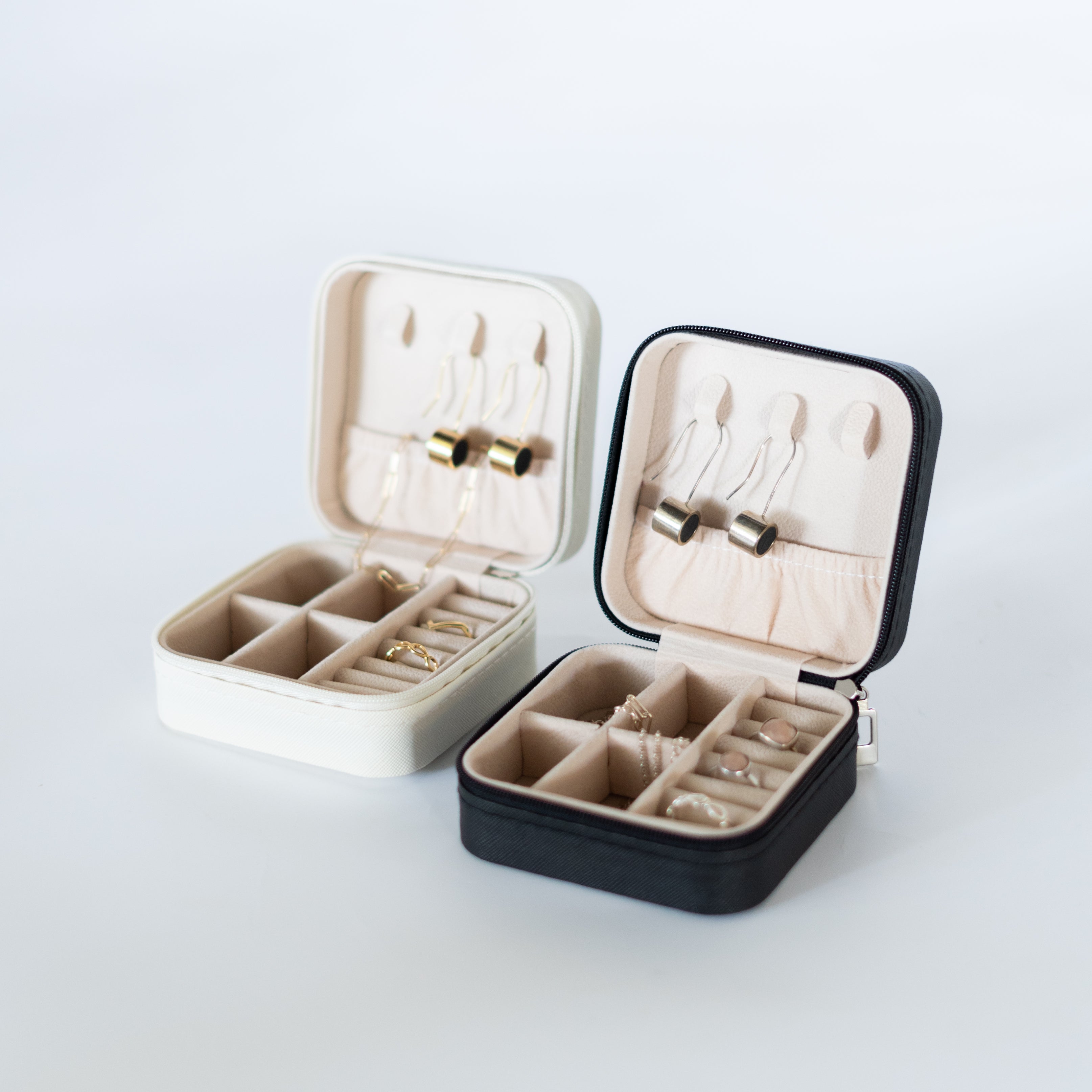 Black mini jewelry case by Bare Threads, compact cod organizer with compartments for rings, necklaces, and small accessories.