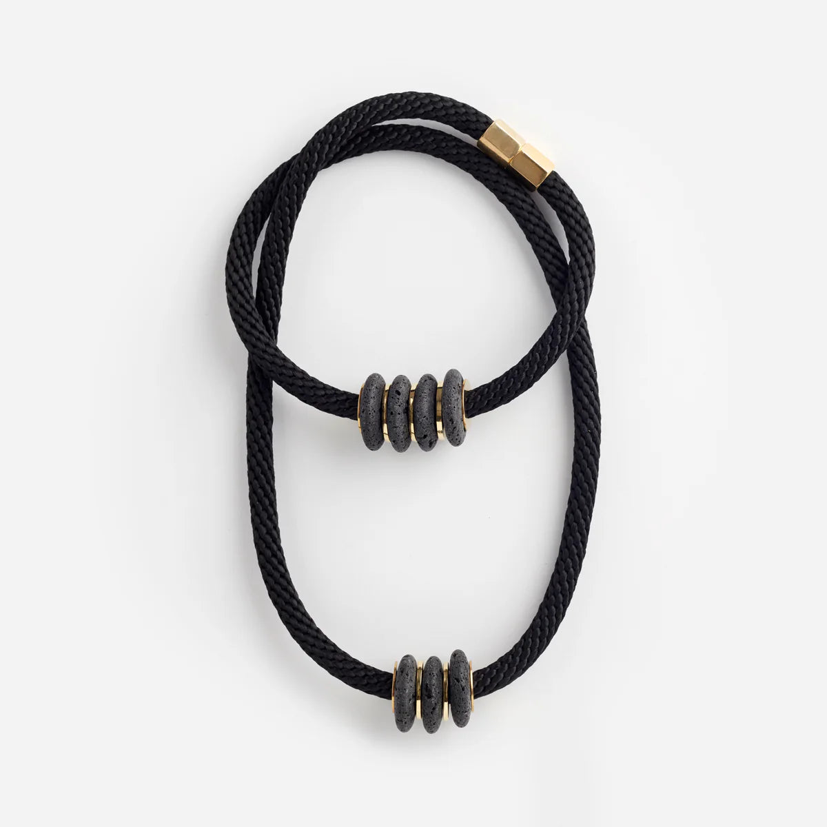 Pichulik Lava Black Magma Necklace featuring bold, textured black lava stone beads on a cord chain.