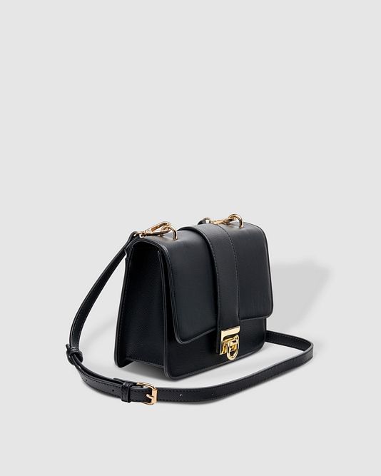 LouenHide Caprice black consignment handbag with sleek design and top handle, shown in the image.