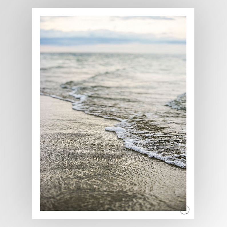 Photografiks Shot by Clint Sea Shore 02 consignment artwork showing a serene coastal scene with waves and sandy beach in natural light.
