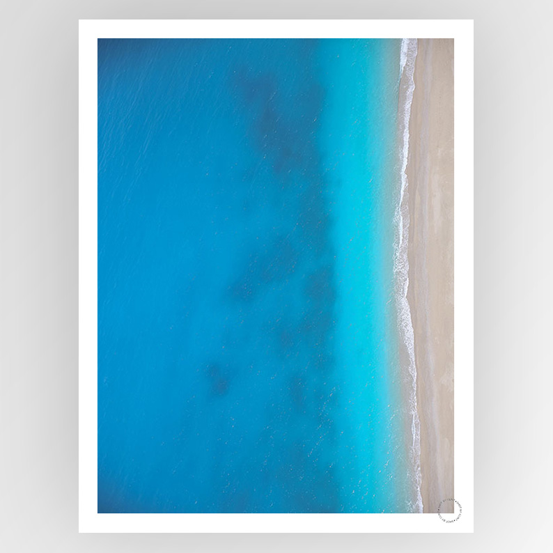Photografiks Shot by Clint Ionian Sea 02 consignment art print displaying a scenic coastal landscape with blue waters and rocky shores.